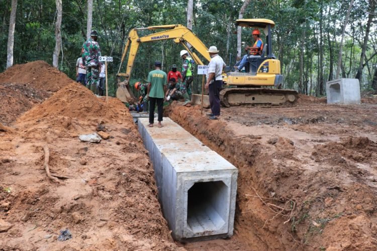 Warga Bersama TNI Gotong Royong Memasang Box Beton Dilokasi TMMD